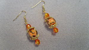 boucles d'oreilles perles d'art oranges en verre fil&eacute; par un artisan verrier